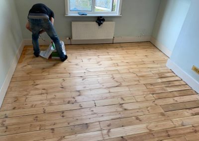 pine floorboards with fire place repair