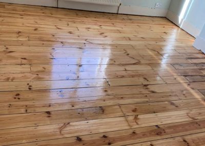 pine floorboards with fire place repair
